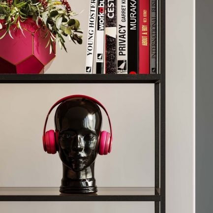 Support-écouteur noir style rétro brillant de la marque Kare Design exposé dans une étagère avec des livres et des plantes